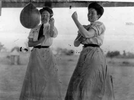 StateLibQld_1_45199_Two_women_sparring_with_a_speed_bag
